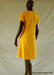 back view of women's yellow knee length cotton dress